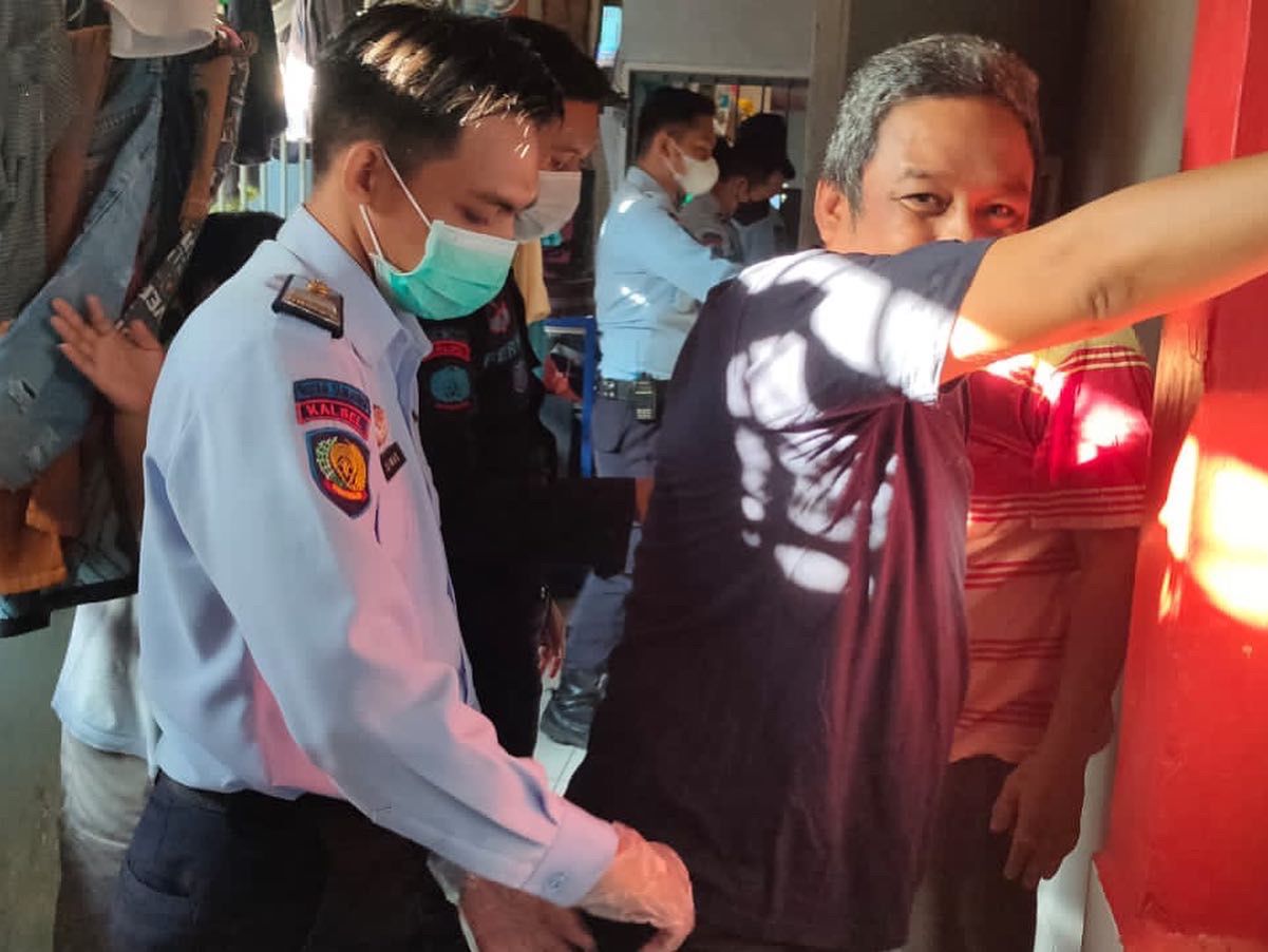 Petugas lapas saat merazia salah satu tahanan