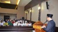 Staf Bupati Bidang Kemasyarakatan, H. Akhmad Mawarni saat membawakan sambutan Pj Bupati Barito Kuala pada kegiatan Rapat Kerja MUI Kabupaten Barito Kuala yang bertempat di Aula Mufakat Setdakab Batola, Senin (29/04/2024).