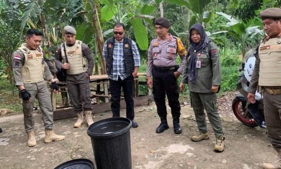 Tidak pandang bulu, Kasatpol PP Balangan, Aspariah, bersama jajaran Sat Sabhara Polres Balangan, mengecek minuman beralkohol tradisional jenis tuak, yang tersimpan di dalam tong air, di Desa Gunung Pandau, Paringin, Balangan. Foto: Satpol PP Balangan